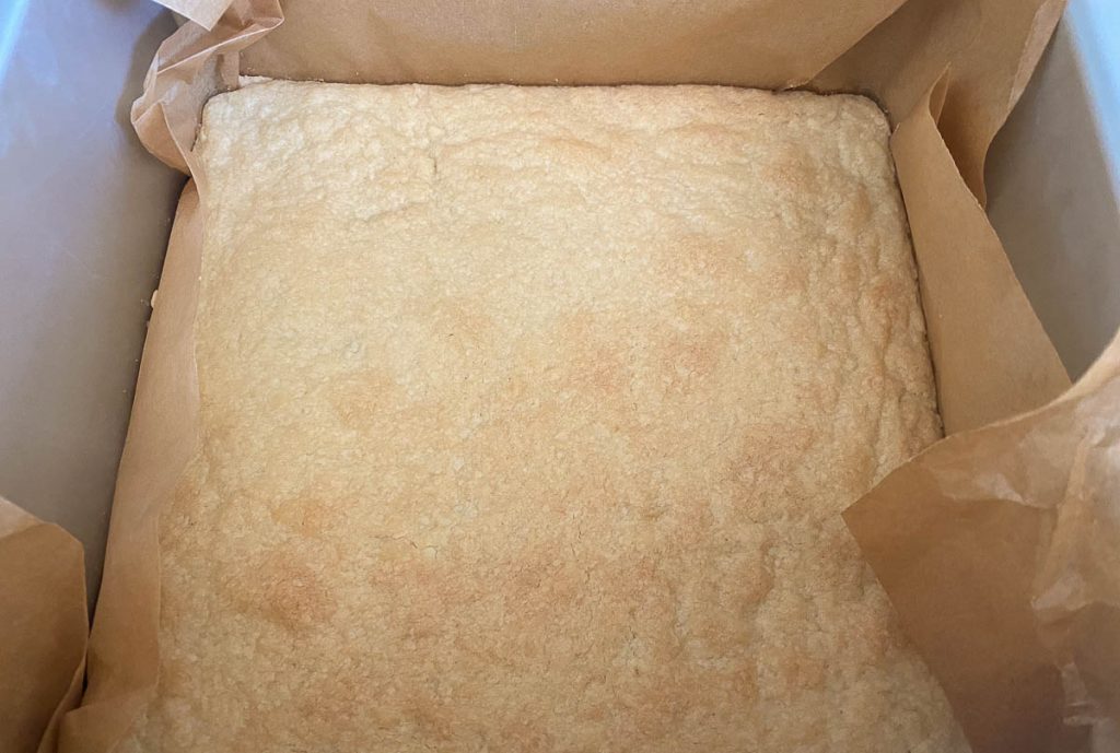 Caramel Shortcake Recipe - Shortbread baked in tin ready for the next layer