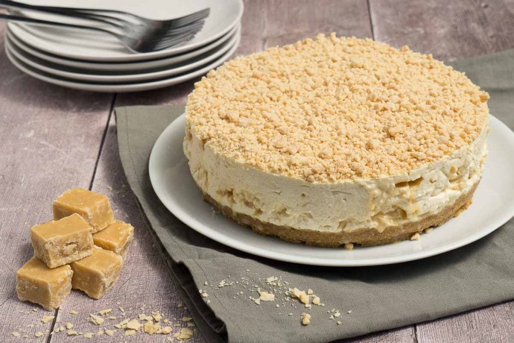 Scottish Tablet Cheesecake Recipe - Whole tablet cheesecake with plates to serve.