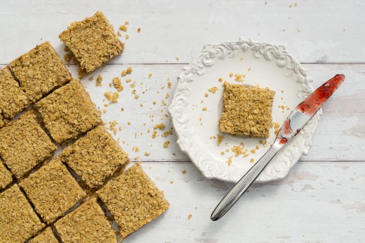 Jam Flapjack Recipe on plate with jammy knife