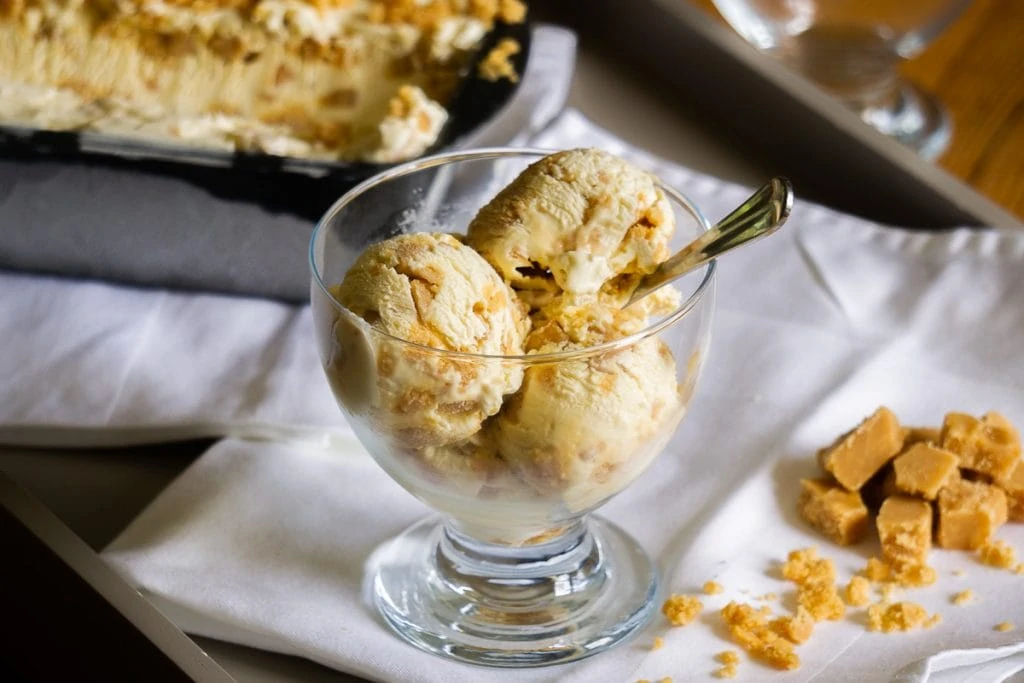 Tablet Ice Cream Recipe in a bowl on a tray with Tablet Ice-Cream tub and Scottish tablet chunks