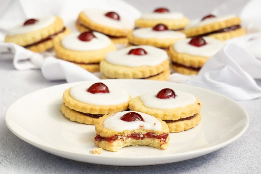 How to Make Empire Biscuits Recipe - Scottish Empire Biscuits on a plate with a bite taken out of one