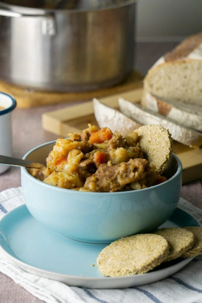 How to make Stovies - Scottish Stovies Recipe in a bowl with oatcakes, bread, and pot