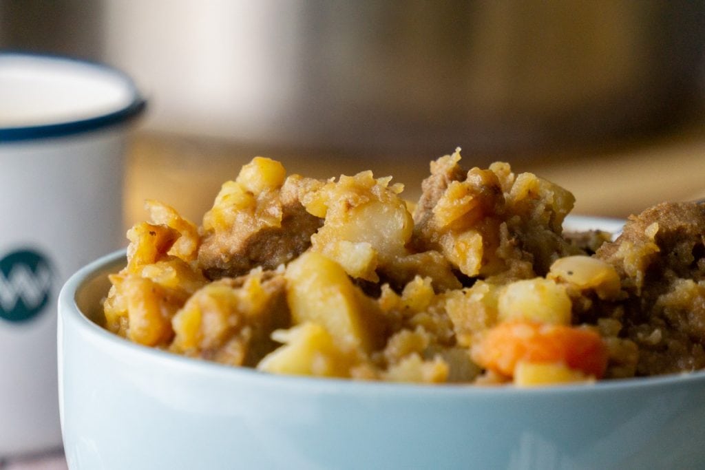 How to make Stovies - Scottish Stovies Recipe in a bowl with a cup of tea