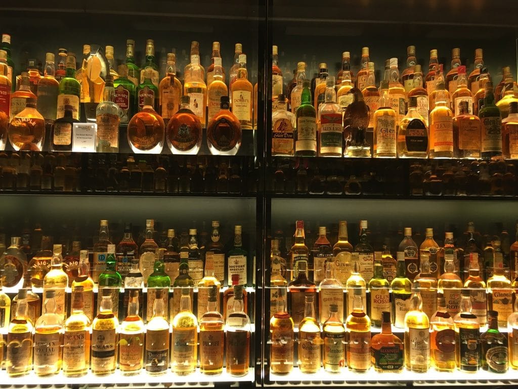 Bottles of Whisky lit behind glass at the Scotch Whisky Experience in Edinburgh